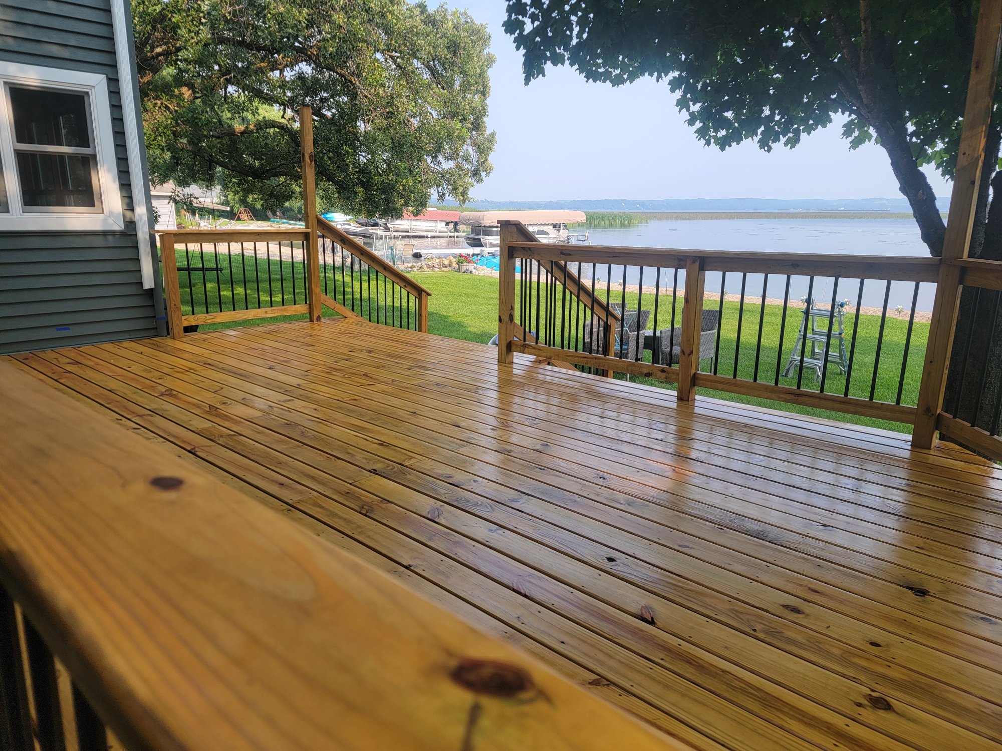 Freshly stained lakeside deck with lake view